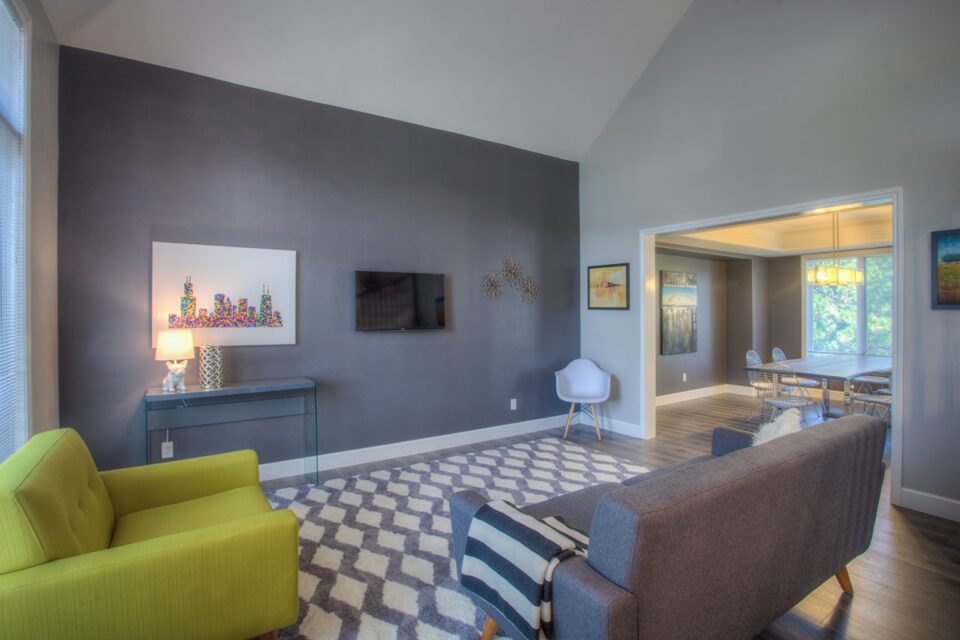 Modern living room with chair and couch, tiled floor