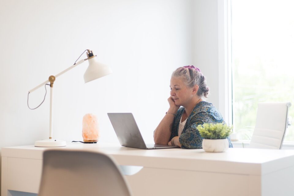 Woman at home office and computer on table